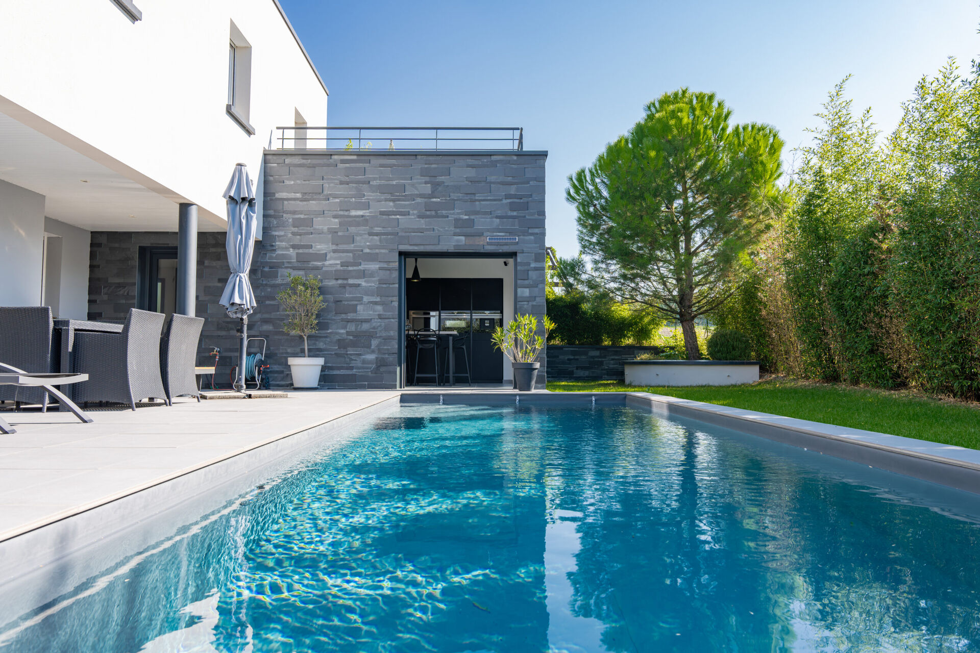 Baie coulissante aluminium sur une maison contemporaine avec piscine